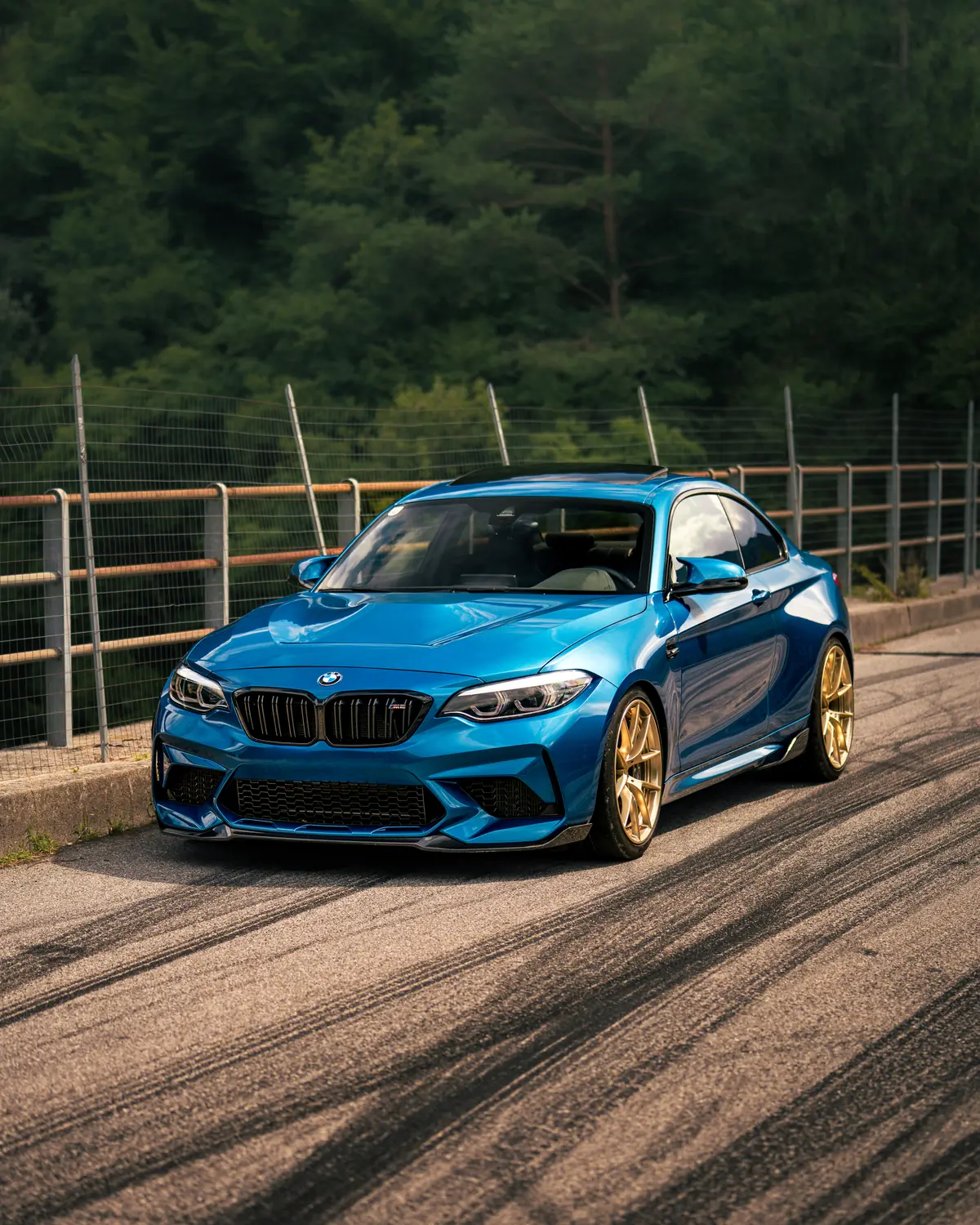 Blauer BMW M2 in Frontansicht auf einer Bergstrasse